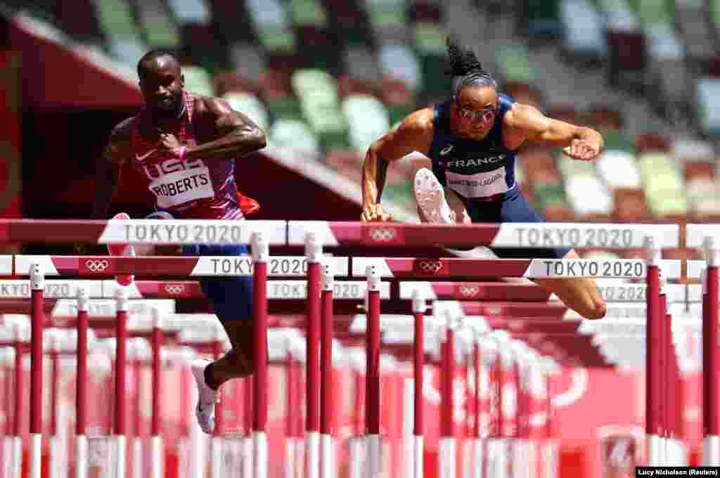 Tokyo 2020 Olympics - Athletics - Men's 110m Hurdles - Semifinal - Olympic Stadium, Tokyo, Japan - August 4, 2021. Pascal Martinot-Lagarde of France and Daniel Roberts of the United States in action in Semifinal 1.