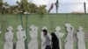 IRAN -- Iranians wearing face masks walk on a street after Iranian authorities made it mandatory for all to wear face masks in public following the outbreak of the coronavirus disease (COVID19), in Tehran, October 10, 2020