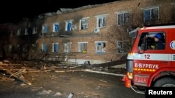 A view shows a fire truck next to a building damaged following a bomb blast at a hospital in Velykiy Burluk, Kharkiv region, Ukraine, on February 1. 