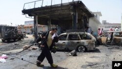 Firefighters work at the site of a deadly suicide attack in Jalalabad, the capital of Nangarhar Province, on July 10.