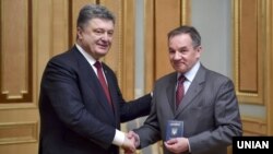 Президент України Петро Порошенко (ліворуч) вручає паспорт громадянина України Мішелю Терещенку. Київ, березень 2015 року