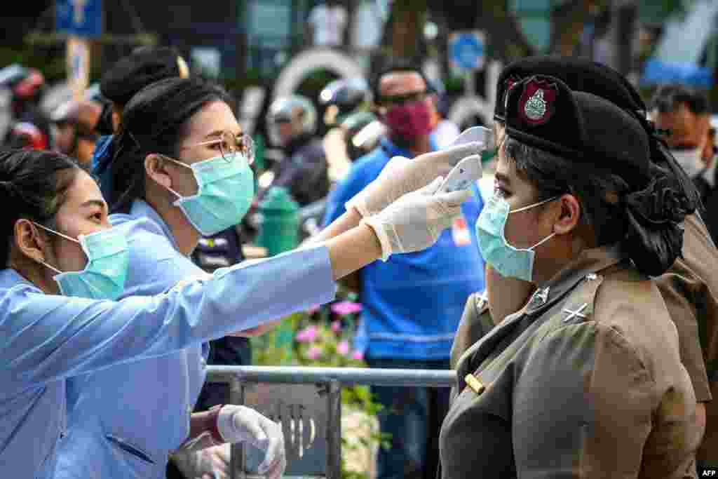 COVID-19 вирусунун жайылып кетүү коркунучунан улам медициналык кызматкерлер полицияда кызмат өтөгөн аялдардын дене табын текшерүүдө. Бангкок, Таиланд. 1-март, 2020-жыл.&nbsp;