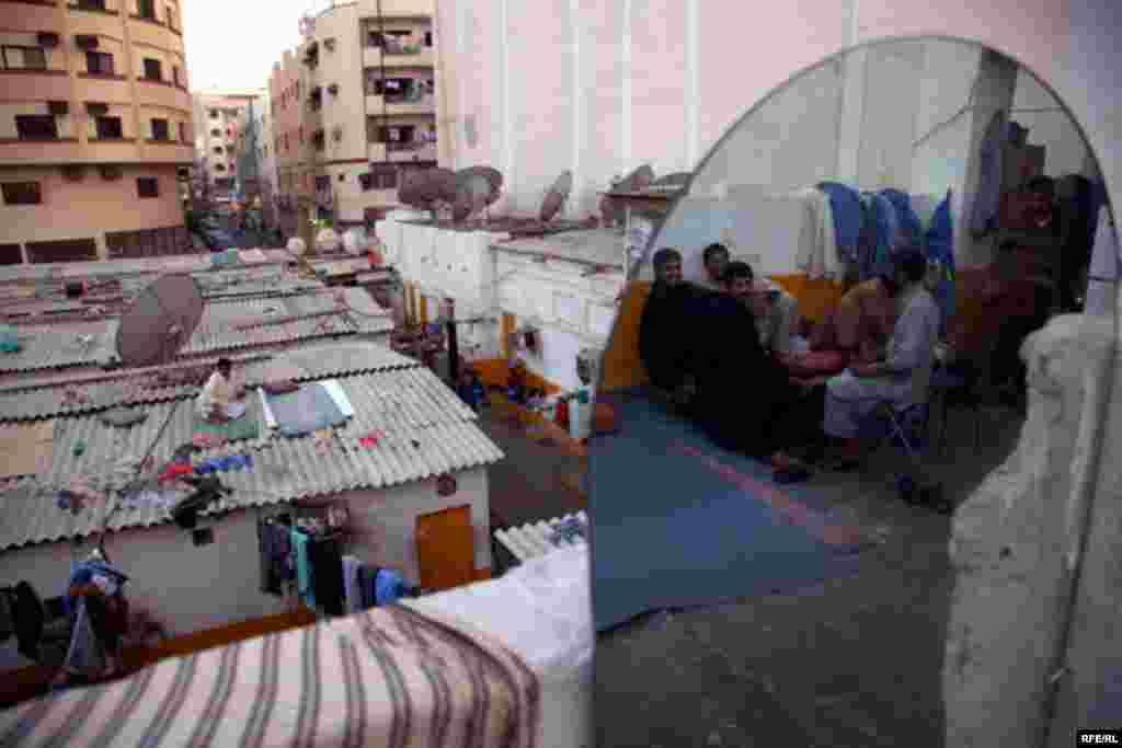 Workers rest after a hard day. Thousands of immigrants, mainly from Pakistan and Bangladesh, live in the Deira district.