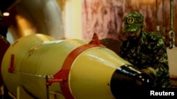 A member of IRGC checks a missile inside an underground depot at an undisclosed location in this handout photo released by the official website of IRGC, March 8, 2016