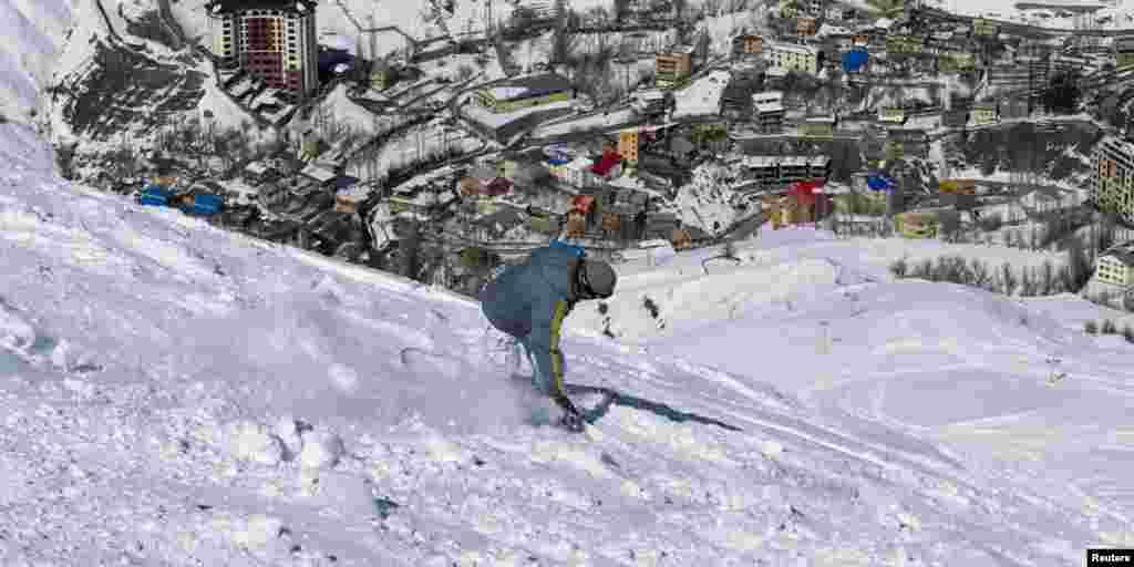 Iran may be facing deepening isolation over its nuclear program, but on the slopes outside Tehran, skiers shrug off suggestions of an escalating crisis. Here, a snowboarder navigates the slopes in Shemshak, 50 kilometers northeast of Tehran.