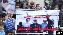 Regime backers hold a poster with doctored pictures of former president Mohammad Khatami and opposition leaders Mir Hossein Musavi and Mehdi Karrubi (right to left) on the gallows during a pro-government demonstration in Tehran on February 18.