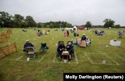 British fans wait for the beginning of the ABBA Mania concert at Scampston Hall in Malton, Yorkshire, on August 29.