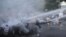 Armenia -- Protesters are hit by a jet of water released from a riot police vehicle during a rally against a recent decision to increase the tariff on electricity, in Yerevan, June 23, 2015.