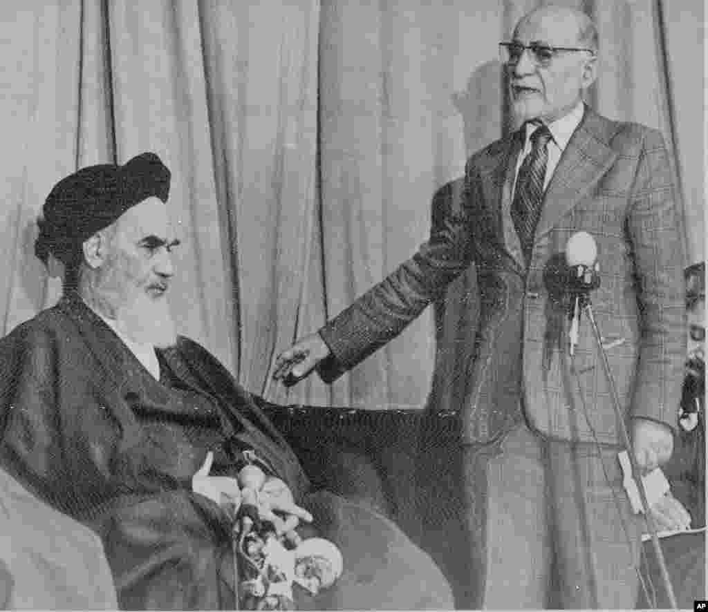 Mehdi Bazargan, newly named Prime Minister of a provisional government in Iran, right, speaks with Khomeini on February 5, 1979.