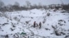 Rescuers with a dog work at the site of a Russian missile strike in the town of Pokrovsk, in Ukraine's Donetsk region, on January 8.