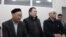 Kenzhebek Abishev (left to right), Almat Zhumaghulov, and Oralbek Omyrov appear in court in Almaty on October 4.