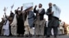 On October 24 Afghans, including religious clerics, hold placards and shout slogans during a protest in Kabul against an allegedly blasphemous article which appeared in the Afghanistan Express newspaper.