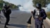 Pakistani police fire tear gas toward protesters marching toward Islamabad on November 26.