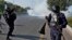 Pakistani police fire tear gas toward protesters marching toward Islamabad on November 26.