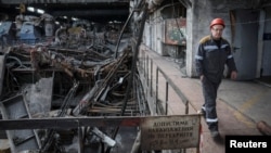 A worker walks at a thermal power plant damaged by a Russian missile strike at an undisclosed location in Ukraine on April 8.