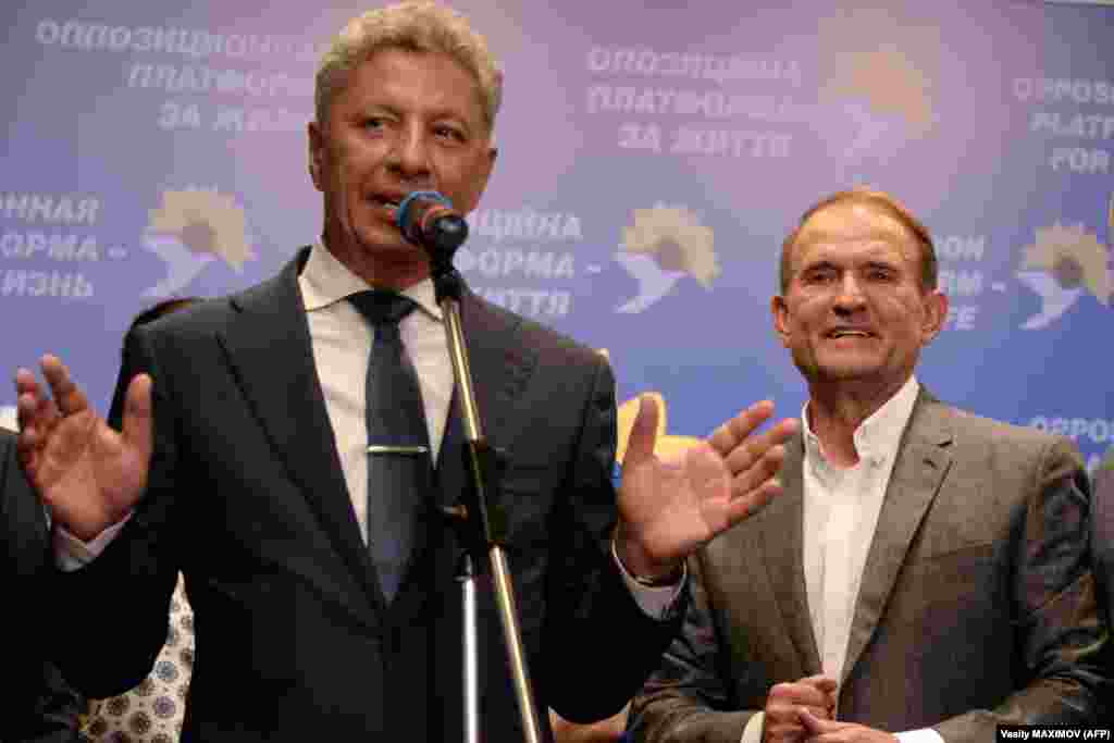 Ukraine&#39;s Opposition Platform-For Life party leaders Viktor Medvedchuk and Yuriy Boyko give a speech at the party&#39;s election headquarters in Kyiv. Early exit polls showed their party, which is pushing for better ties with Russia, was on track to come in second with 11.5 percent of the vote. (AFP/Vasily Maximov)