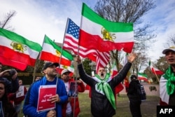 Protestors celebrate the death of Ayatollah Ali Khamenei, who was killed following an attack on Iran by the United States and Israel in The Hague on March 1, 2026.