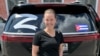In an undated social media image, Yelena Smirnov, a travel agent from Ryazan, is seen in front of a car showing a Cuban flag and the letter "Z"-- a symbol for Russia's war on Ukraine.