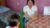 A social worker talks with a victim of domestic violence at at crisis center in Karaganda. (file photo)