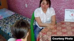 A social worker talks with a victim of domestic violence at at crisis center in Karaganda. (file photo)