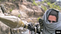 A Pakistani Taliban wields a rocket-propelled grenade launcher near Buner in mid-April.