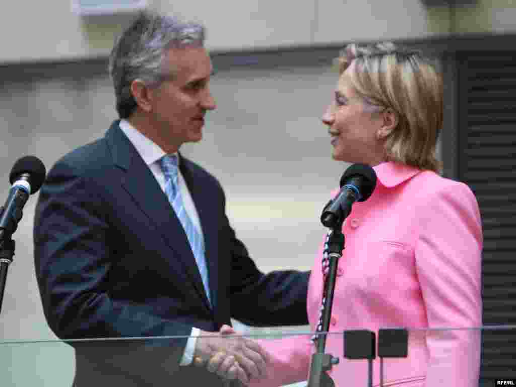 The Secretary shakes hands with President Gedmin before her remarks.