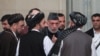 FILE: Former Afghan President Hamid Karzai (2nd R) and cheif Taliban negotiator Mullah Abdul Ghani Baradar (3rd R) talk in Moscow.