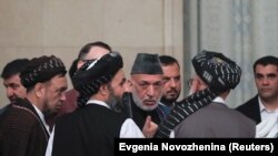 Former Afghan President Hamid Karzai (center) talking to the Taliban officials in Moscow on May 28. 