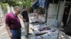 People reading headlines in front of a newspaper stand in the Iranian capital Tehran, May 20, 2019 - FILE PHOTO