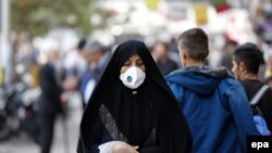 An Iranian woman wearing a mask in a street in Tehran, November 16, 2016.