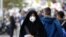 An Iranian woman wearing a mask in a street in Tehran, November 16, 2016.