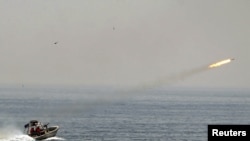 An Iranian boat fires a missile as it takes part in naval war games in the Persian Gulf and the Strait of Hormuz last month.