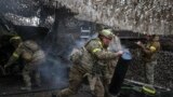 Soldiers from the 15th Brigade of Ukraine's National Guard of Ukraine fire artillery near Kupyansk in May. 