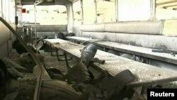 A bus was damaged in the January 6 explosion in Damascus. The Syrian regime said 26 people were killed in the blast.