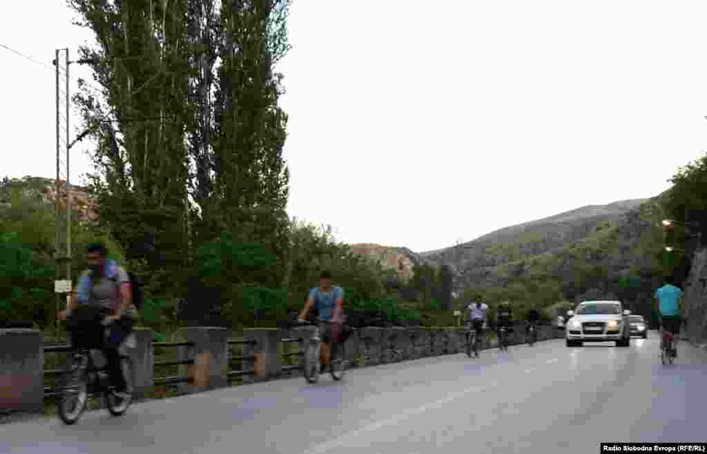 Syrian migrants ride bicycles through the city of Veles on their way to Macedonia&#39;s border with Serbia. From there, most aim to enter Hungary, inside the European Union&#39;s visa-free travel zone.