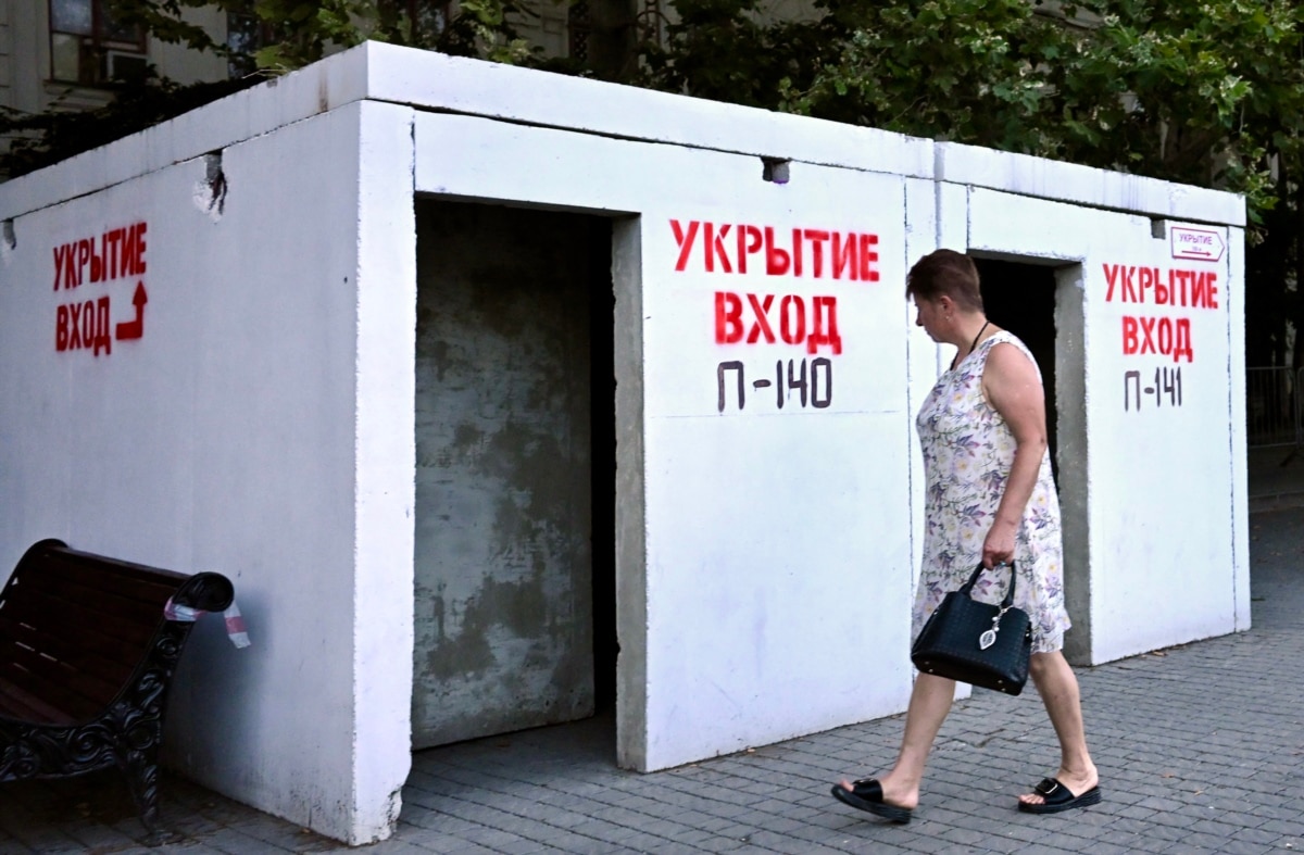 A resident of Sevastopol walks past a shelter, 22 July 2026