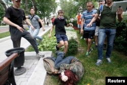 Antigay youths kick a gay-rights activist during a protest against Russia's homosexual "propaganda" law in Moscow in June 2013.