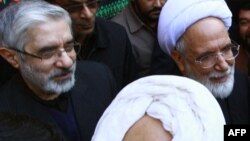 Opposition leaders Mir Hossein Musavi (left) and Mehdi Karrubi in Qom in December 2009