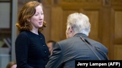 NETHERLANDS -- Jennifer Newstead (left), lawyer of the United Statess, and representative of Iran Mohsen Mohebi talk during the opening of case between Iran and the U.S. at the The International Court of Justice (ICJ) in the Hague, August 27, 2018