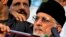 Tahirul Qadri (R), a Pakistani-Canadian cleric, is surrounded by security personnel as he speaks to supporters during protest in Islamabad, Pakistan.