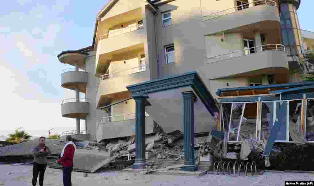 A large residential building in Durres that appears to have collapsed its first floor. 
