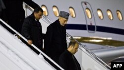 Afghan president Hamid Karzai (second from right) arrives at Gardemoen Airport in Oslo on February 4.
