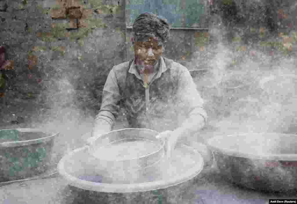 A worker prepares gunpowder to make firecrackers at a factory ahead of Diwali, the Hindu festival of lights, on the outskirts of Ahmedabad, India. (Reuters/Amit Dave)