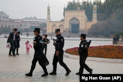 Security personnel patrol near the Id Kah Mosque in Kashgar in Xinjiang.