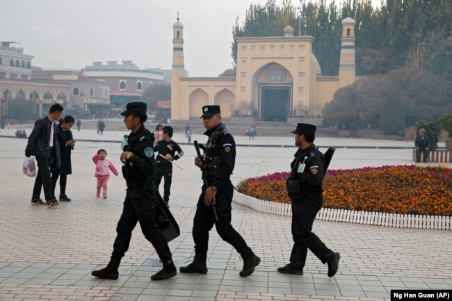 Security personnel patrol near the Id Kah Mosque in Kashgar in Xinjiang.