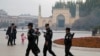 Uyghur security personnel patrol near the Id Kah Mosque in Kashgar in western China's Xinjiang region, in 2017.