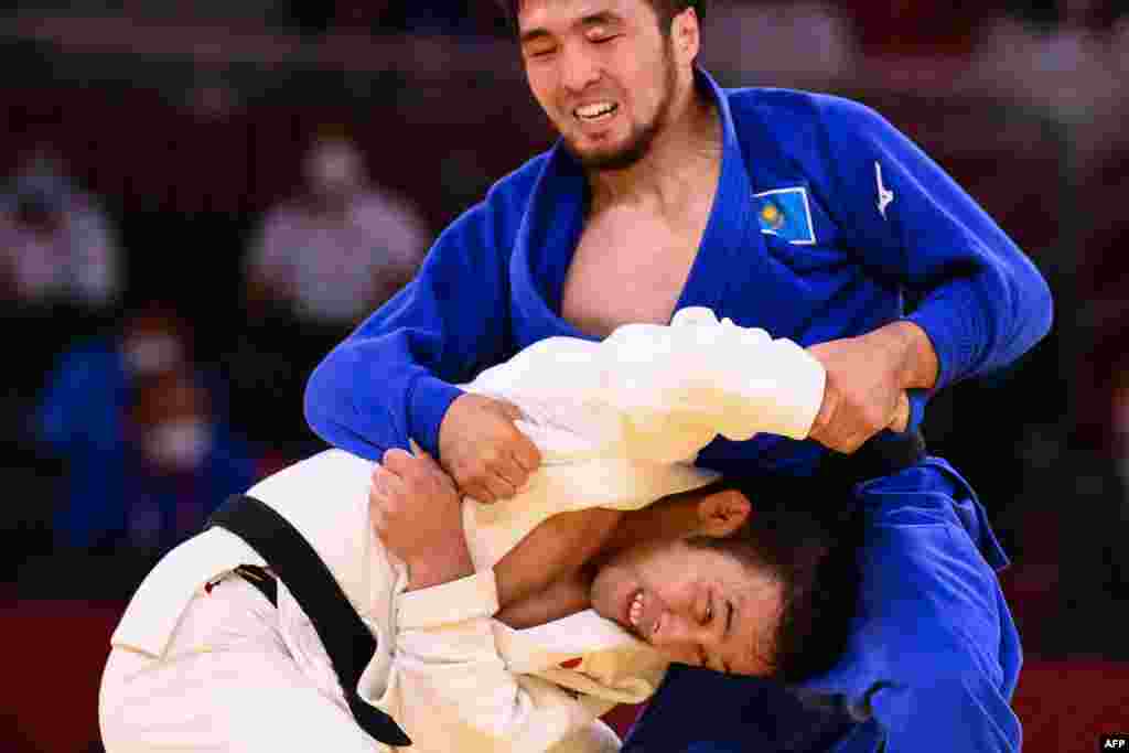 Japan&#39;s Naohisa Takato (in white) competes with Kazakhstan&#39;s Yeldos Smetov during their judo men&#39;s under-60kg semifinal bout during the Tokyo 2020 Olympic Games in Tokyo on July 24.