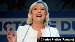 French far-right leader Marine Le Pen reacts after her party's strong showing in EU parliamentary elections on May 26. 