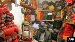 An Iranian Azeri shopkeeper reads a newspaper in Tabriz. (file photo)