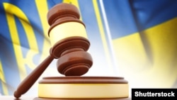 Ukraine – Wooden gavel and flag of Ukraine as background (©Shutterstock)